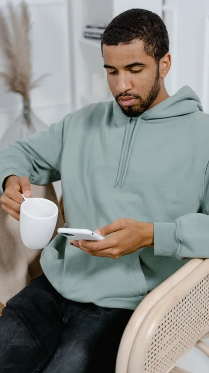 Finished vertical clip of a man reviewing a video on his phone